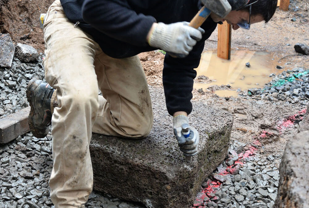 Chiseling basalt blocks